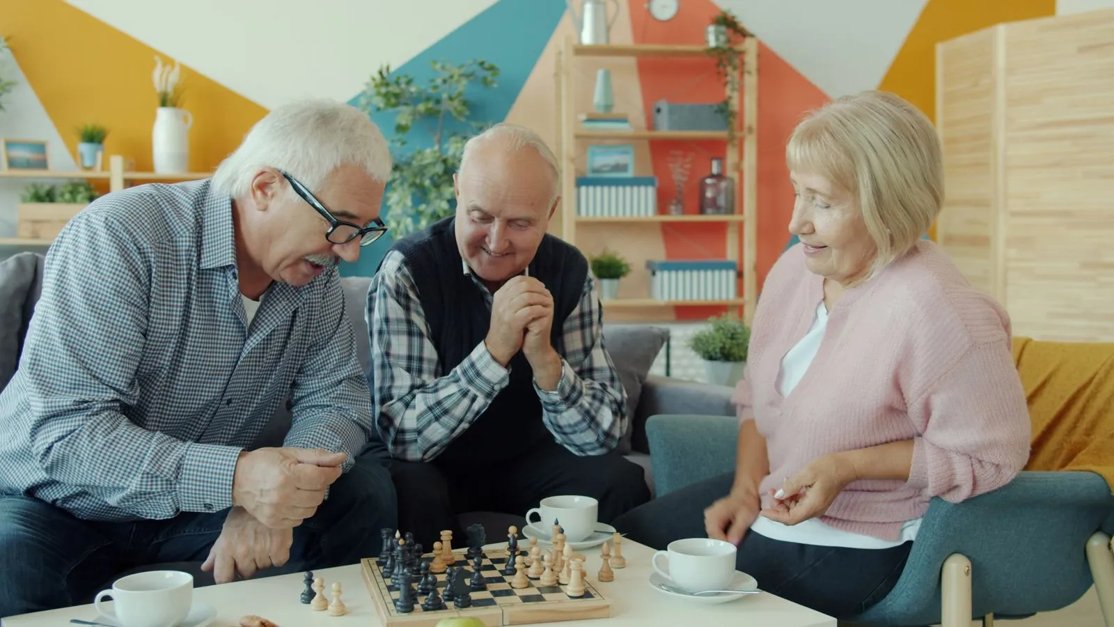 Senior adults playing chess together, fostering companionship and strategic thinking.